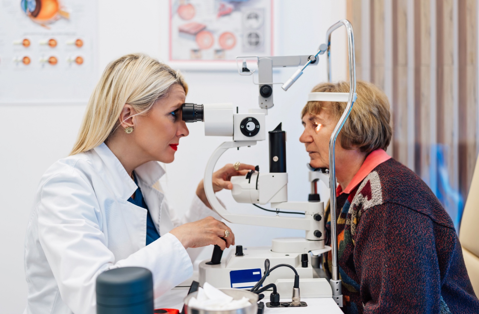 A healthcare professional uses a slit lamp to examine a patient’s eyes during an eye exam.