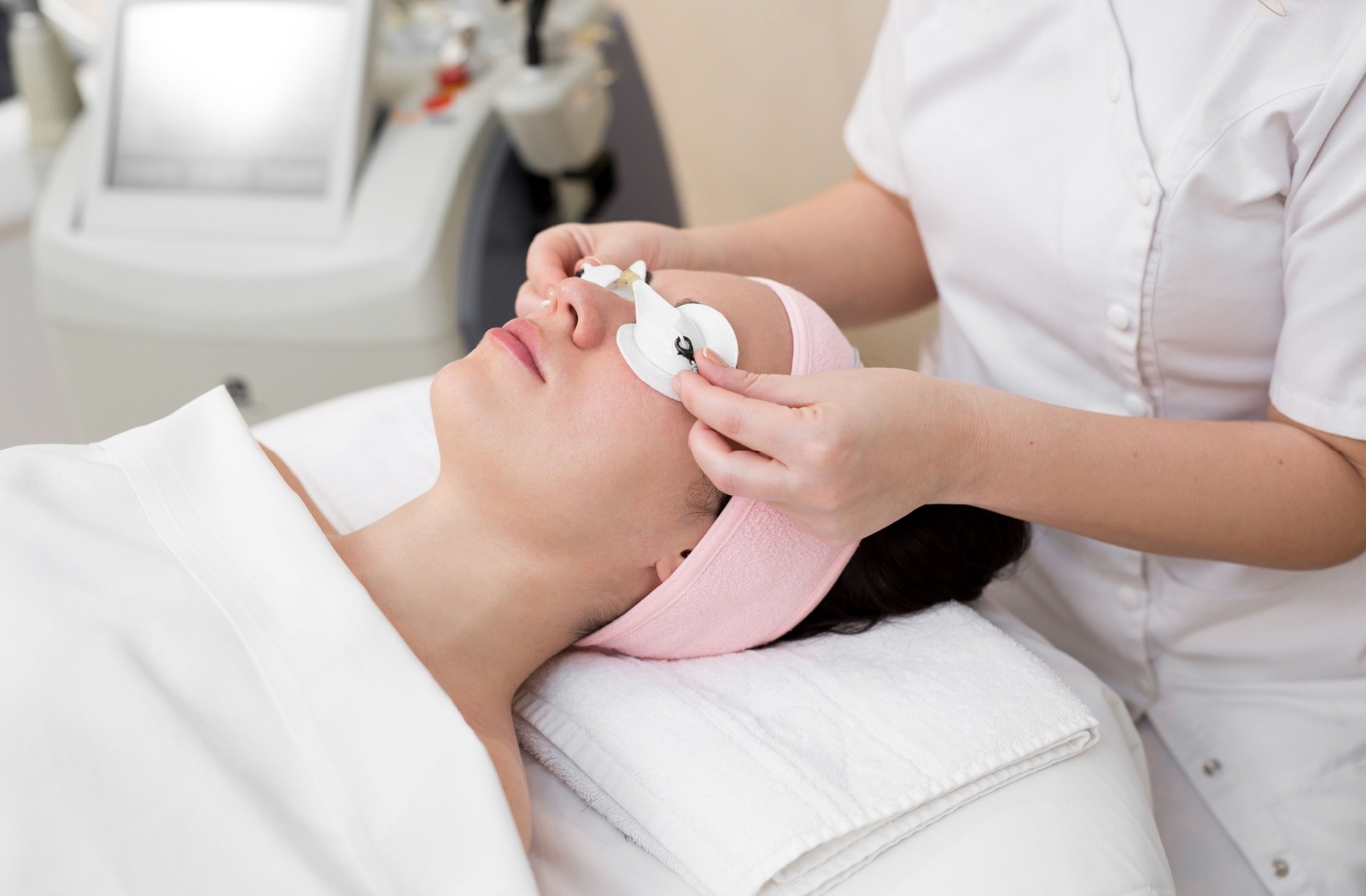 Person laying on a treatment bed preparing for an IPL treatment for their dry eyes